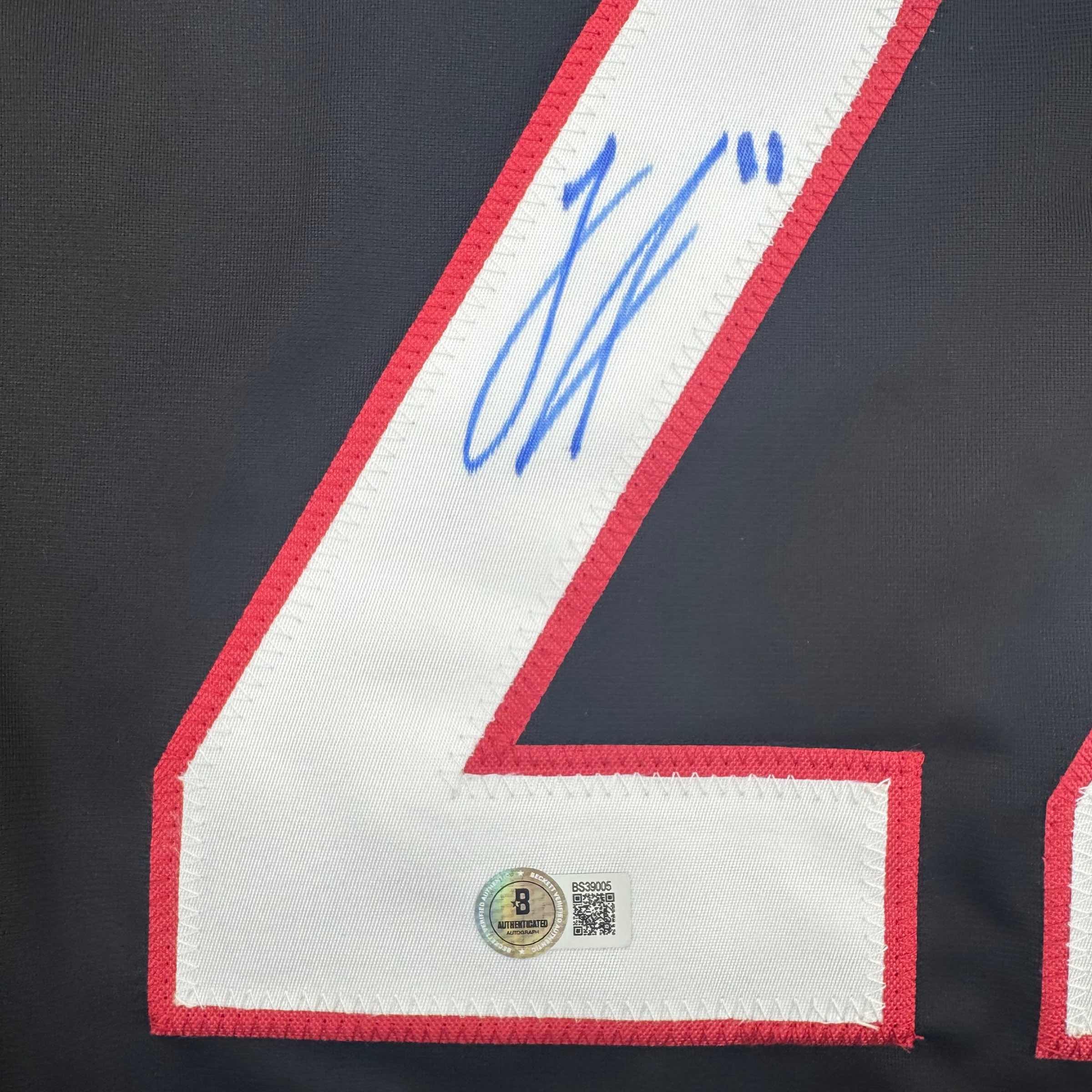 Autographed/Signed Logan Stankoven Carolina Black Hockey Jersey Beckett BAS COA