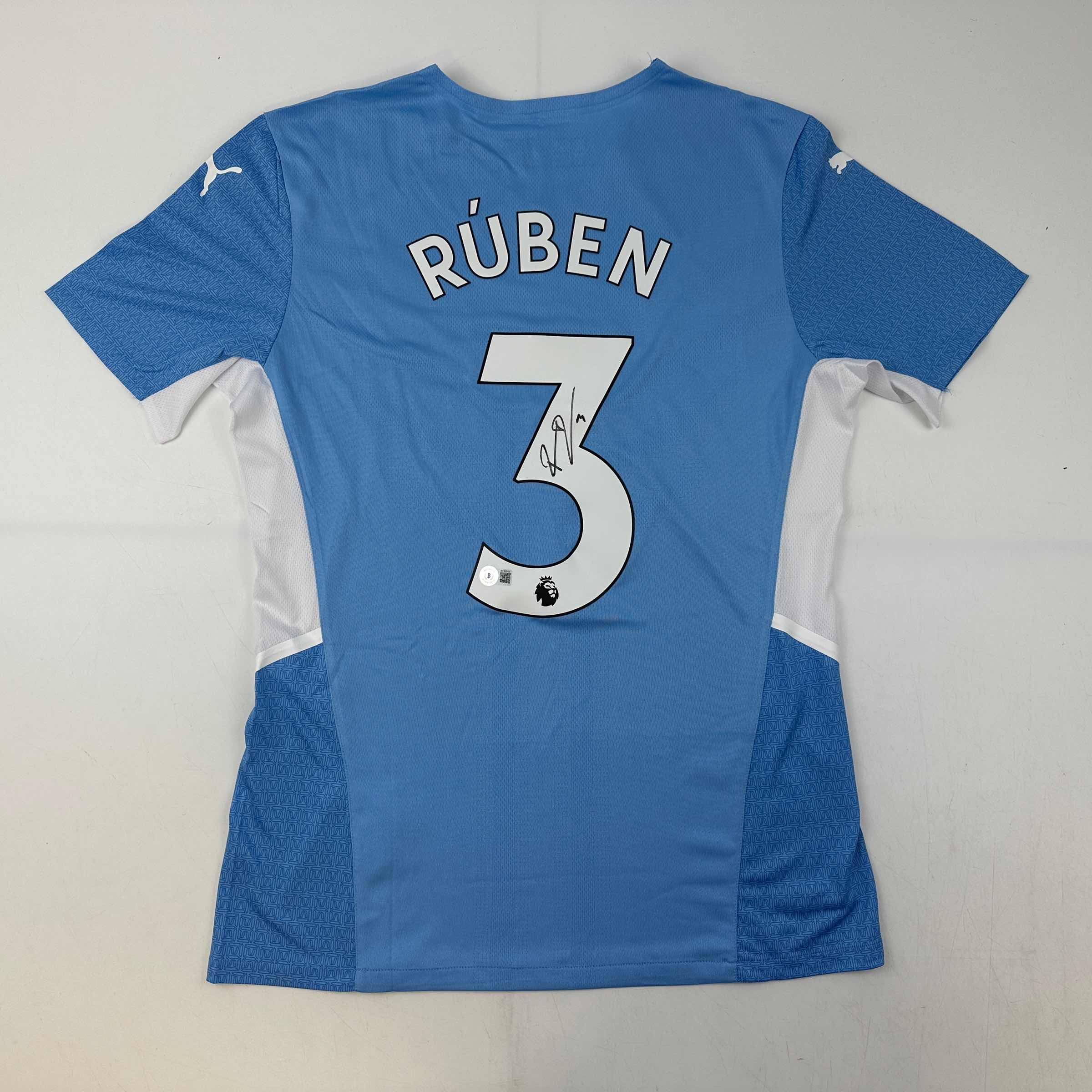 Autographed/Signed Ruben Dias Manchester City Blue Soccer Futbol Jersey Beckett BAS COA