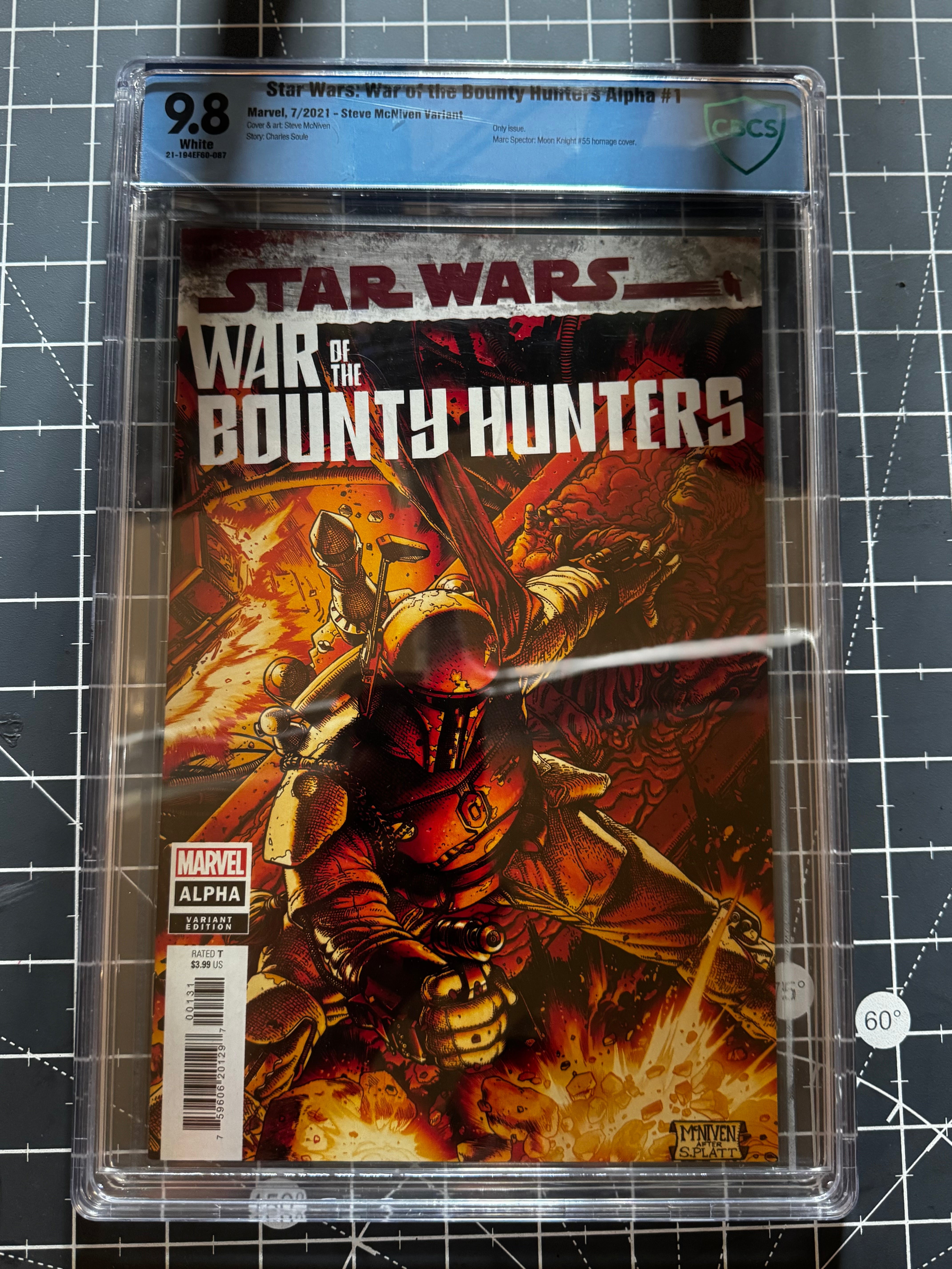 Comic book 'Star Wars: War of the Bounty Hunters' Alpha in a clear plastic case on a grid background