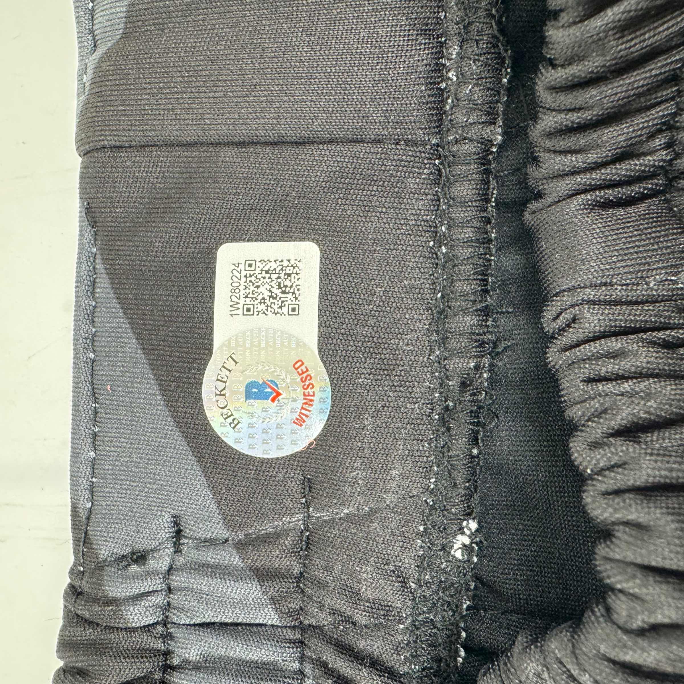 Autographed/Signed Stipe Miocic Black and Gold UFC MMA Trunks Shorts Ultimate Fighting Beckett BAS COA